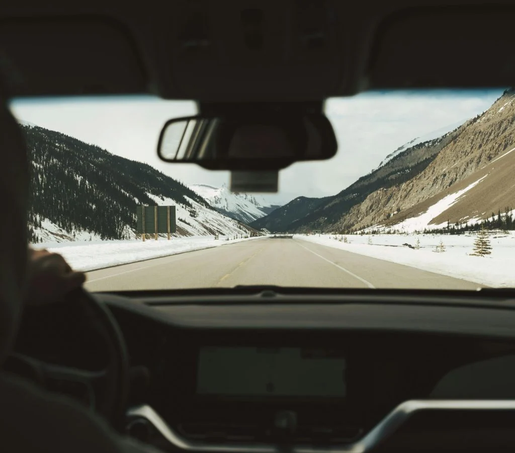 Winding Canadian road surrounded by mountains and lakes