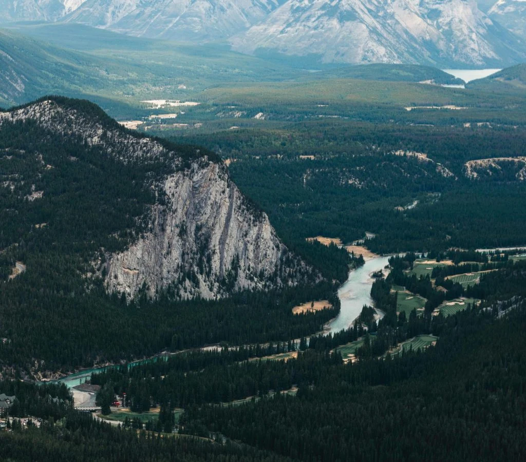 Aerial view of a river valley in Canada surrounded by mountains and forests