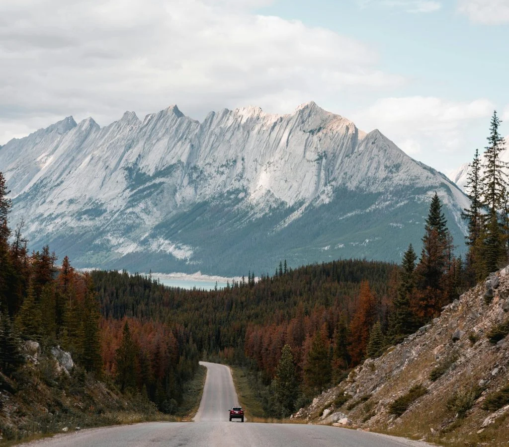 Winding roads through Canadian landscapes with mountains and lakes