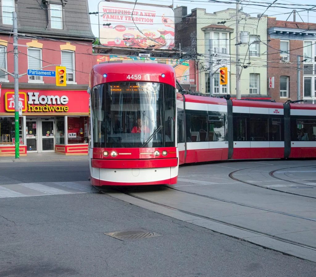 Photo of a bustling Canadian city street with diverse architecture and people