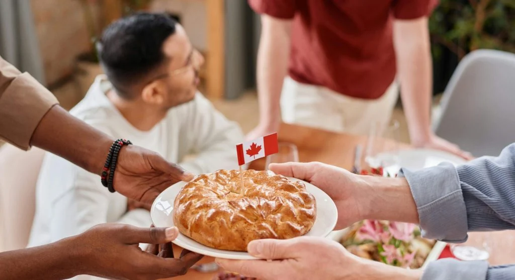 People from diverse backgrounds gathering for a meal in a community center