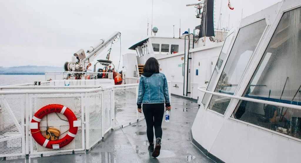 Ferry with passengers viewing Canadian regional scenery from the deck