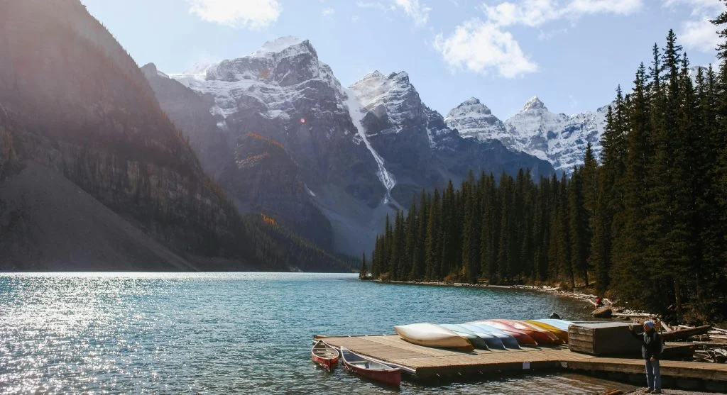 Person wearing outdoor clothing on a scenic mountain stop in Canada