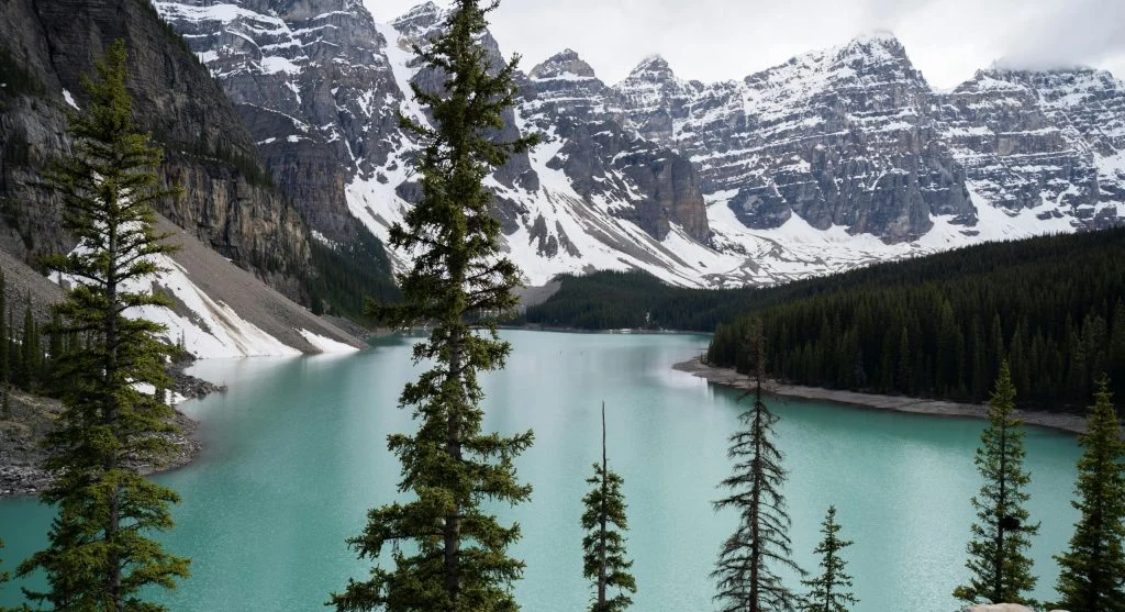 Serene Canadian landscape with mountains and lake under clear blue sky