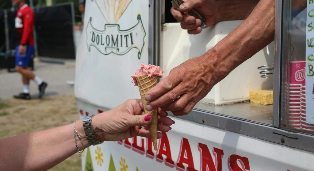 Colorful ice cream stands in Canadian neighborhoods with people gathered around