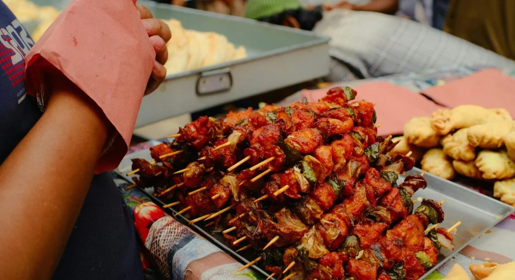 Crowd of people gathering at a small-town food festival in Canada, with local food vendors and community activities